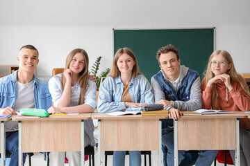 Sticker - Happy classmates sitting at desks in classroom