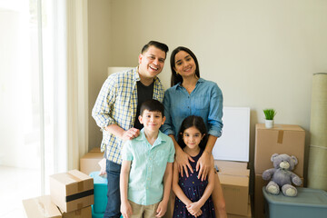 Smiling family moving into a new rental house