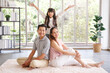 © aekkorn - Real estate and mortgage concept : Family with child having fun in new home. Joyful first-time buyers in living room. Real estate, residential mortgage, moving into dream house.