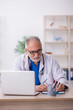 © Elnur - Old male doctor working in the clinic