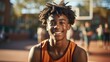 © visoot - Portrait of a young African American boy smiling on a basketball court.