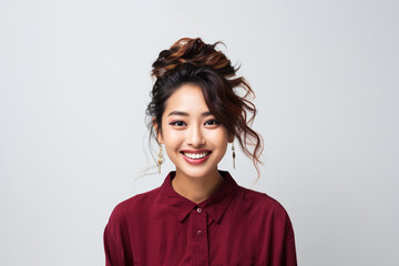 Portrait of a smiling young woman with good health glowing skin and positivity standing and looking at the camera on white background.