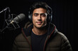 © PRASANNAPIX - Happy young male radio host broadcasting in studio