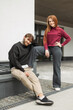 © alones - Beautiful happiness fashion couple in fashionable clothes posing on the street. Happy handsome hipster man and red-haired fashionable girl with smile in stylish pullover