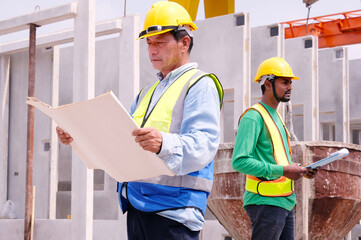 Engineer working at construction site, prefabricated cement wall factory.