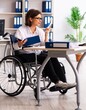 © Elnur - Female employee in wheel-chair at the office