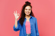 © ViDi Studio - Young smiling happy cheerful satisfied woman of African American ethnicity she wear blue shirt casual clothes showing okay ok gesture isolated on plain pastel pink background studio Lifestyle concept
