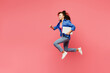 © ViDi Studio - Full bocy side view young IT woman of African American ethnicity wear blue shirt casual clothes jump high hold use work on laptop pc computer run isolated on plain pink background. Lifestyle concept.