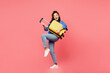 Traveler woman wears blue shirt casual clothes hold suitcase pov play guitar isolated on plain pink background. Tourist travel abroad in free spare time rest getaway. Air flight trip journey concept.