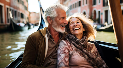 Happy mature couple on a gondola trip during a vacation. Concept of travel, tourism and sightseeing at a senior age, enjoying retirement. Shallow field of view.