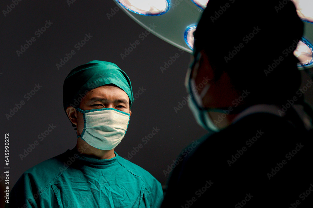 Surgery Look In Professional surgeon doctor standing under bright light, using surgical ...