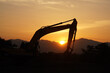 silhouette of excavator machine with sunset