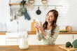 © Art_Photo - Portrait of beauty healthy asian woman smiling and having protein breakfast drinking and hold glasses of milk of fresh milk, nutrition,calcium and vitamin,dairy product in kitchen at home.Diet concept