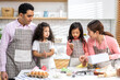 © Art_Photo - Portrait of enjoy happy love asian family father and mother with little asian girl daughter child play and having fun cooking food together with baking cookie and cake ingredient in kitchen