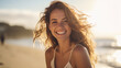 © MP Studio - Young woman smiles happily while on vacation with the beach in the background