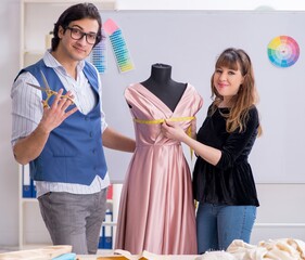 Wall Mural - Young tailors working in workshop