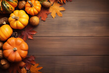 Autumn Composition Of Maple Leaves, Pumpkins And Pine Cones On Brown Wooden Background.