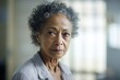 Inside pale walls of hospital room, biracial woman in golden years rejecting reality that she needs help with basic tasks. reliance on denial defense mechanism allows to navigate difficult