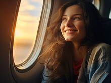 Woman In The Airplane Looking Out Window