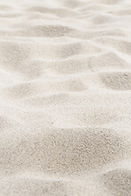 Fine Sand Texture Natural View. Close Up Of Sand On Shore Sea, White Waves Dunes, Beige Neutral Color, Minimal Nature Aesthetic Vertical Photo. Sandy Beach For Background, Selective Focus
