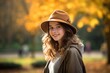 © urdialex - young caucasic girl with a whoolen hat girl walking in the park in autumn