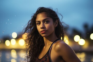 Wall Mural - young latin woman outdoors looking to the camera with a smile