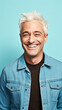 © Patrick - Man in the age range of 45 years old, happy and white hair, isolated on light blue background