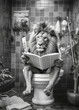 Lion sit on the toilet in a robe, reading a newspaper, leo sitting on the potty, restroom humor, black and white