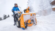 © Sabrewolf - Snow Removal Equipment. Clearing snow from access road using a snow blower.