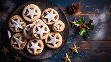 Freshly Baked Christmas Mince Pies Adorned With Star-shaped Pastry On A Ceramic Plate.