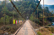 Hanging wooden bridge on Railey river surrounded by mountains at Bidyang Valley in Kalimpong district of India
