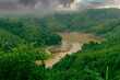 During the rainy season, the thick green hills blend into the thick black clouds in the sky. Sangu river flows below. Hilly region of Bandarban district of Bangladesh.