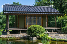 Tea House Behind Pond In Japanese Garden