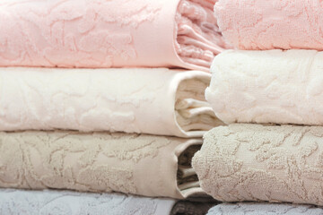 Poster - Colorful folded towels stack closeup picture, hotel service concept background