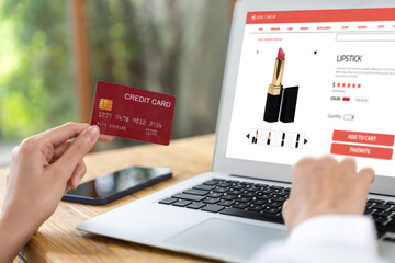 Woman shopping online on internet marketplace browsing for sale items for modern lifestyle and use credit card for online payment from wallet protected by uttermost cyber security software