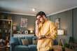 © Miljan Živković - One adult man with eyeglasses at home use mobile phone have problem