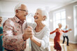 An older couple dance at a dance class at assisted living nursing home facility
