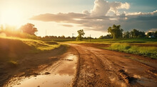 Dirt Road With Mud And Grass With Sunset Light