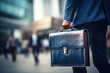 © Danny - business person with briefcase walking in street with blurry background