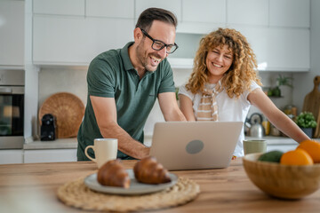 happy couple man and woman husband and wife morning routine use laptop