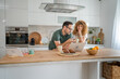 © Miljan Živković - happy couple man and woman husband and wife morning routine use laptop