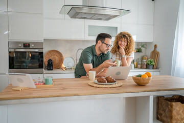 happy couple man and woman husband and wife morning routine use laptop