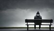 © ibreakstock - Anxiety solitary man in hoodie sitting on bench from behind against empty dark grey background with copy space