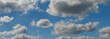 white and gray clouds in the blue sky, layered rain clouds, stratocumulus, cumulonimbus, background, wallpaper for projects, sky spectacularly illuminated by sunlight