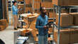 © DC Studio - Small business owner scanning bar code on carton boxes, working on doing merchandise inventory in warehouse space. Male worker taking packages from sorage room racks and checking them.