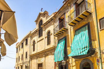 Historic building in street of Cefalu town, an attractive destination in Sicily, Italy, Europe.