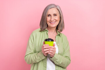 Sticker - Photo of cheerful adorable lady office agent wear green trendy clothes enjoy aromatic cappuccino isolated on pink color background