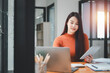 © Mongta Studio - Serious focused woman looking at laptop screen, touching chin, sitting at desk, home office, thoughtful businesswoman pondering strategy, working on online project, searching information