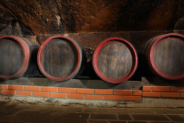 Wall Mural - Many wooden barrels with alcohol drinks in cellar