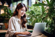 © pariketan - Asian japanese chinese student girl smile using notebook laptop, woman studying online hybrid learning in coworking third space